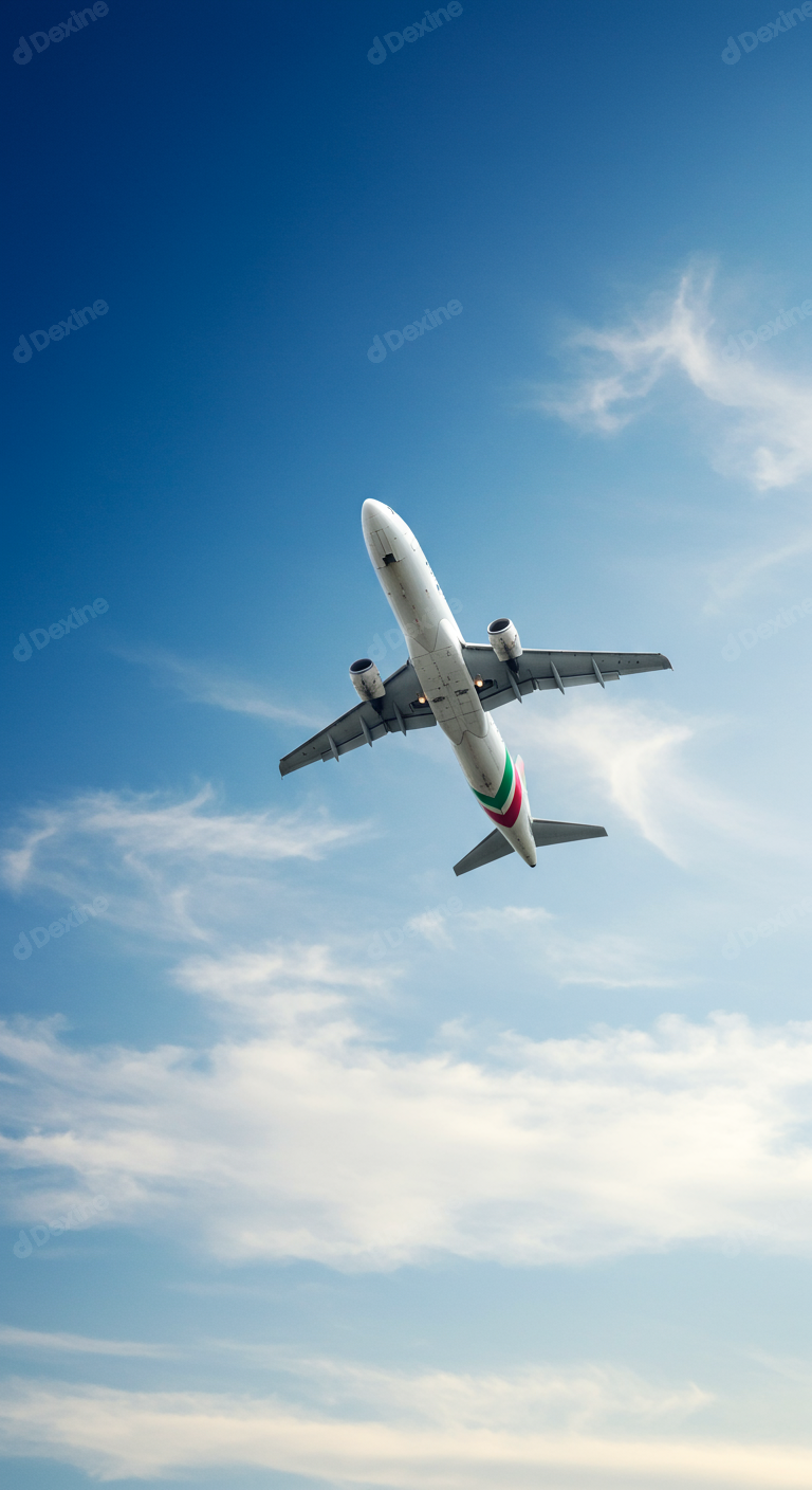 Commercial Passenger Airplane Flying High In A Blue Sky