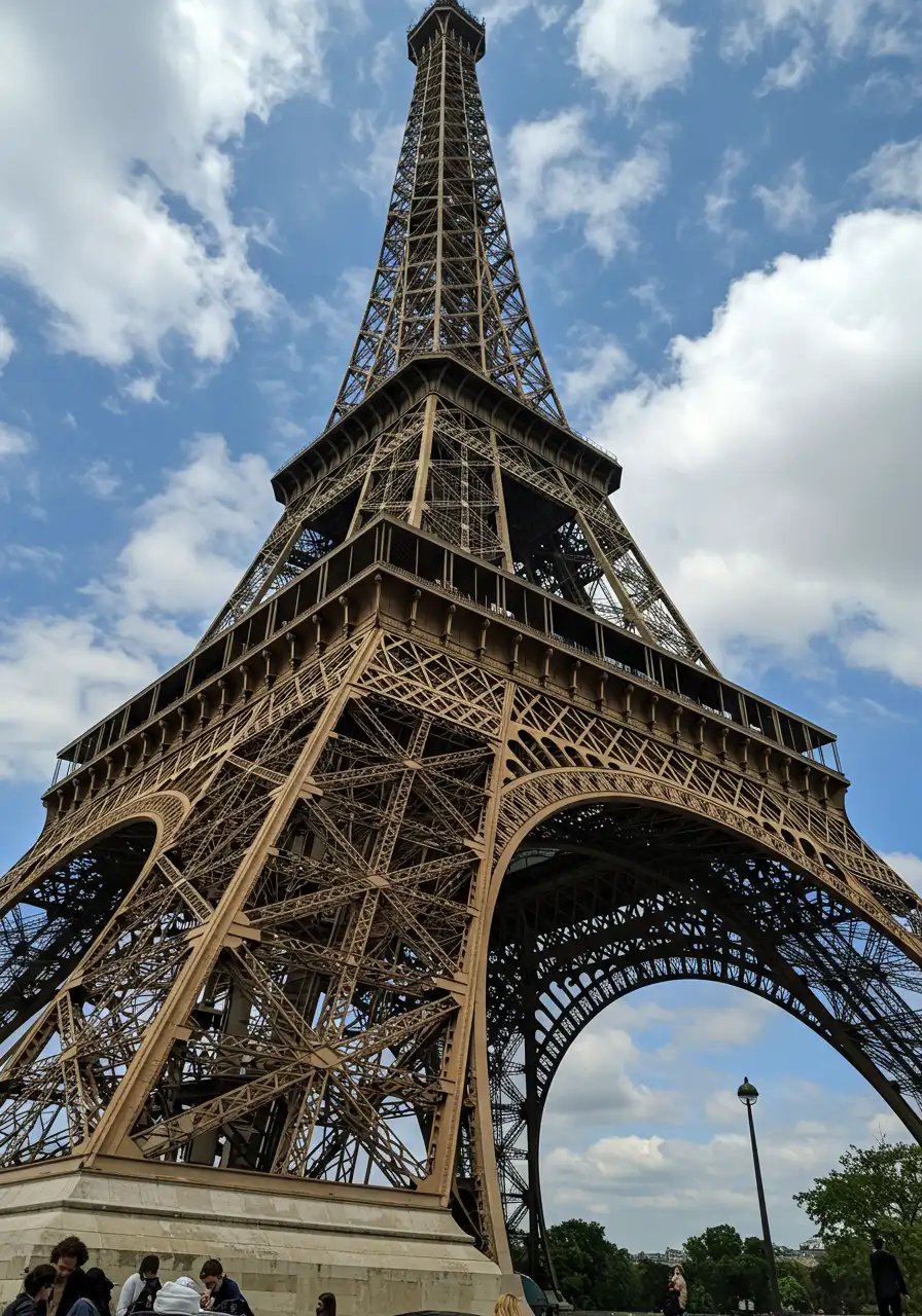 Iconic Eiffel Tower In Paris Under Blue Cloudy Sky