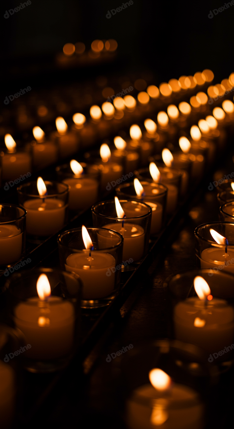Rows Of Burning Votive Candles Illuminating A Dark Space