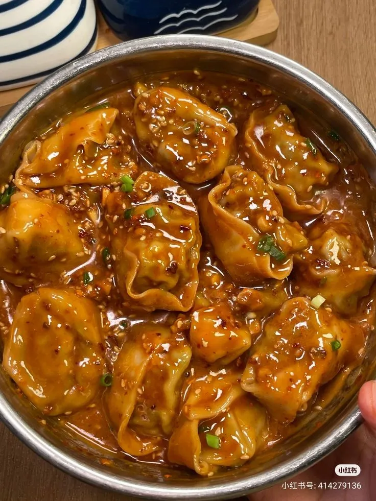 a person is holding a bowl full of food