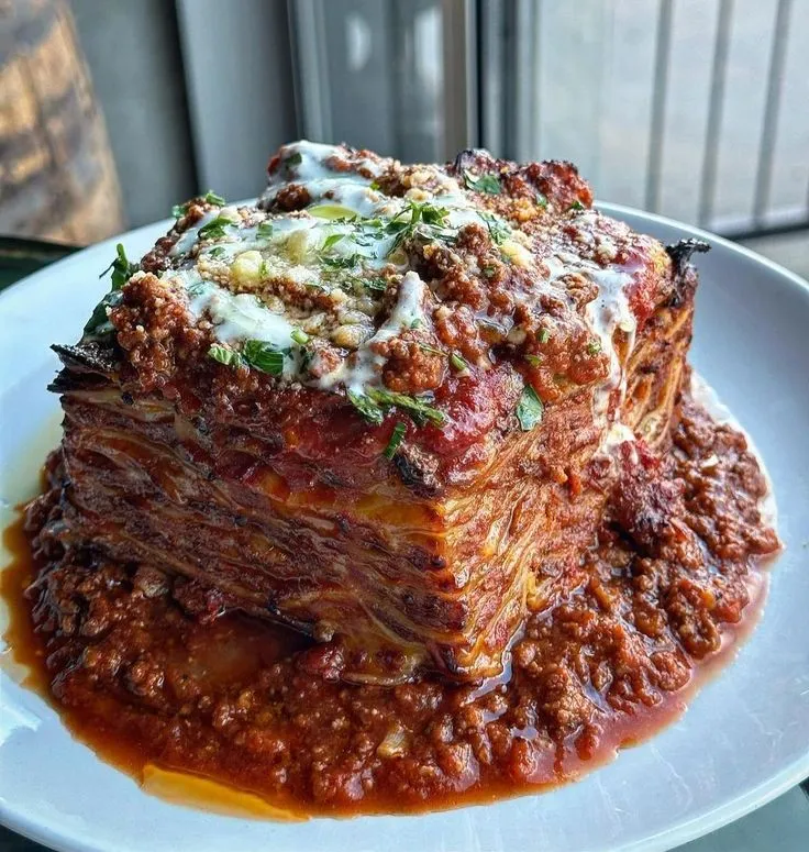 Lasagna with bolognese ragu, black truffle béchamel, mozzarella, parmigiano