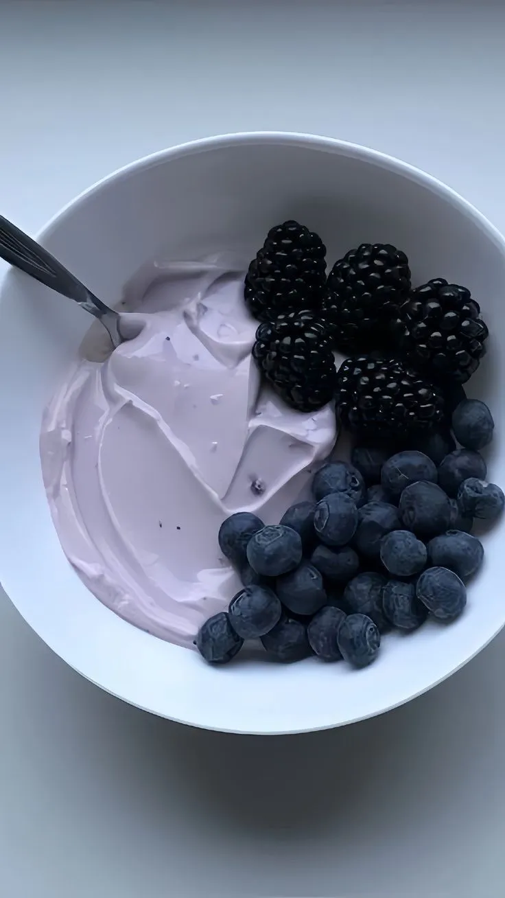 a bowl filled with yogurt and berries
