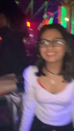 a woman wearing glasses is smiling for the camera