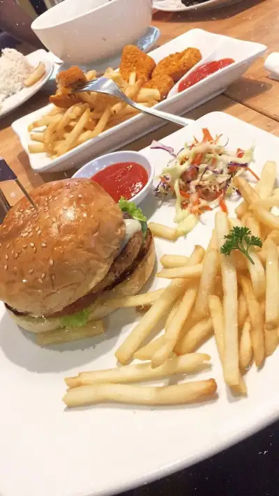a hamburger and french fries on a white plate
