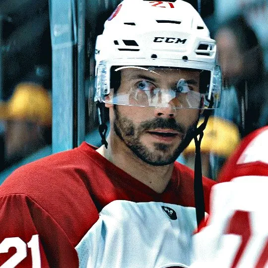 a close up of a hockey player wearing a helmet