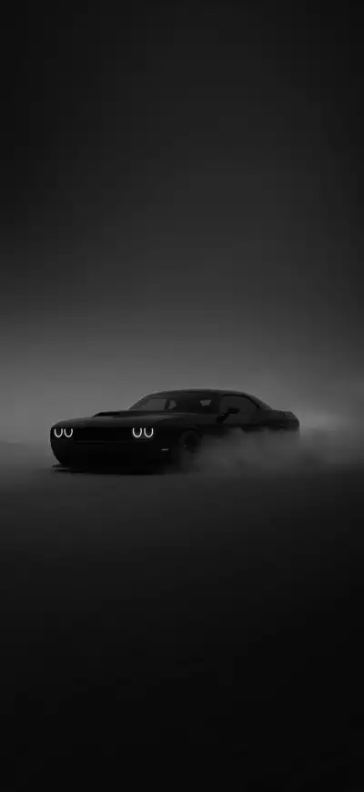 a black car in the dark with fog coming out of it's hoods