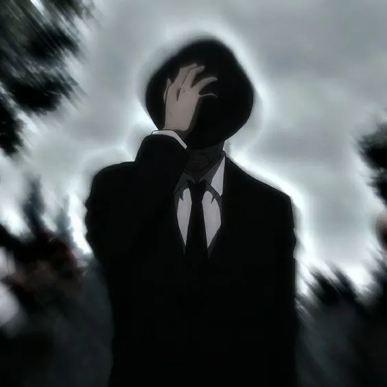 a man in a suit and tie holding his hand up to his face