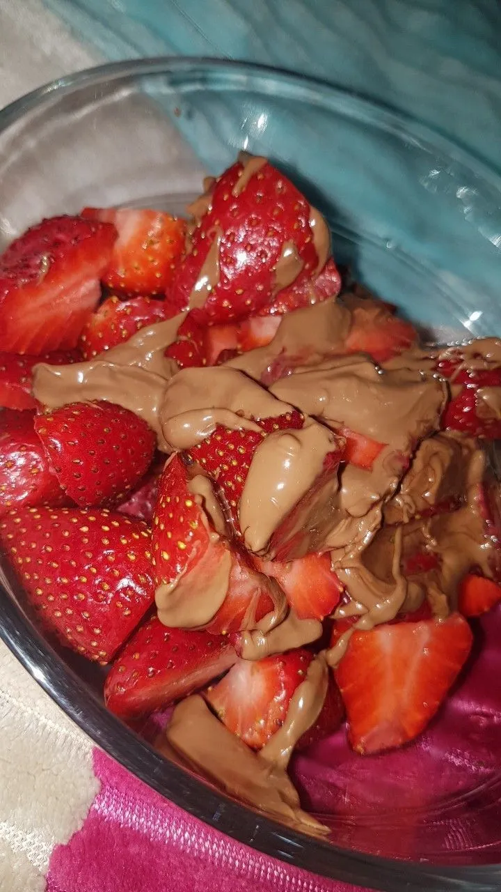 a bowl filled with strawberries covered in chocolate