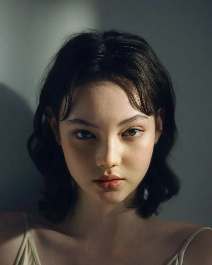 a woman with dark hair and blue eyes