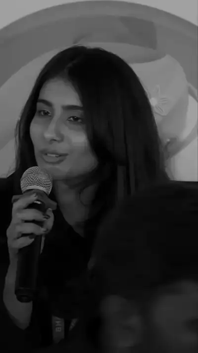 a woman holding a microphone in front of her face