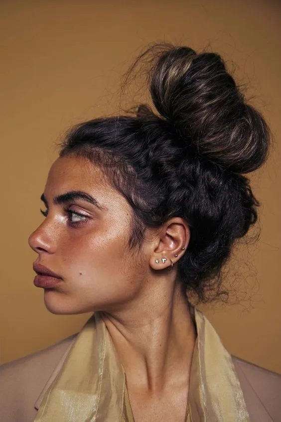 a woman with her hair in a bun