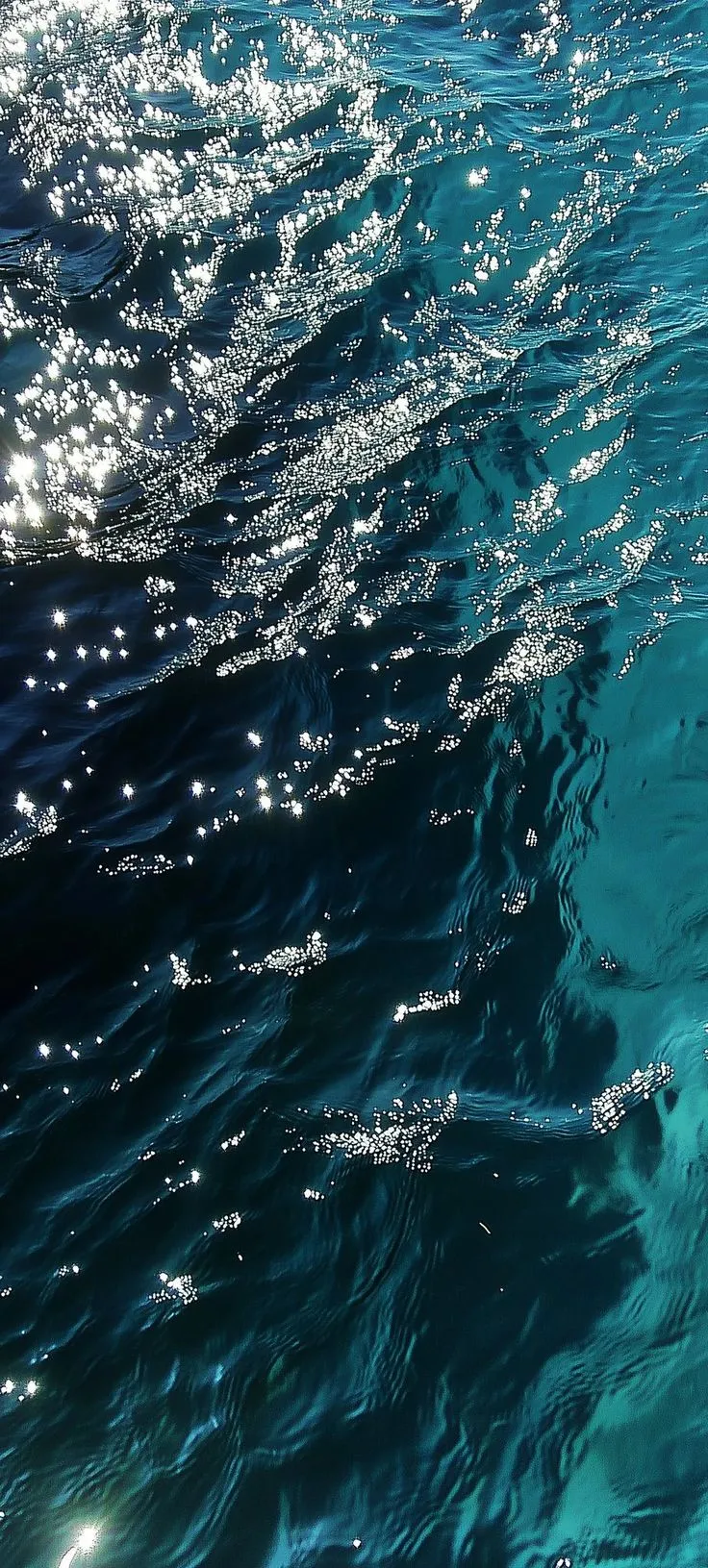 the sun shines on the water as it reflects in the blue ocean waters surface