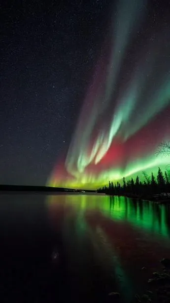 the aurora lights are reflected in the water