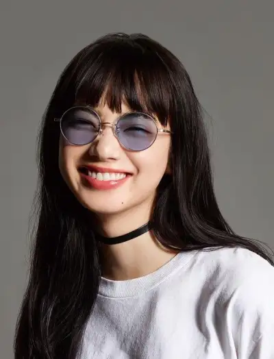 a woman with long black hair wearing sunglasses