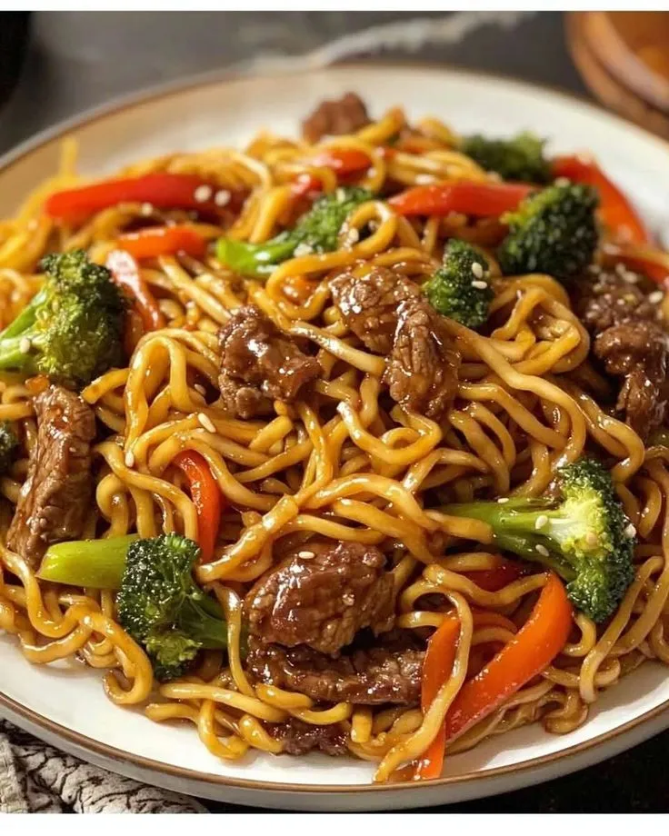 a white plate topped with beef and noodles