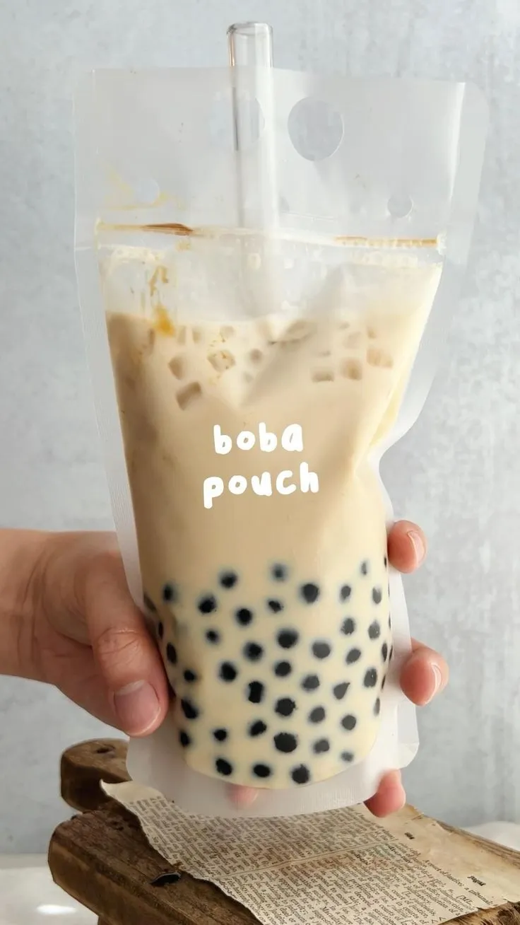someone holding up a bubble tea bag with the word boba pouch printed on it