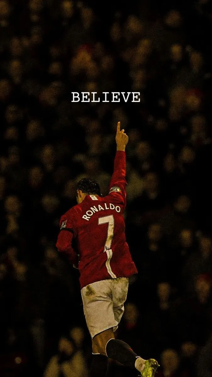 a soccer player jumping in the air with his arms up and one hand raised above his head