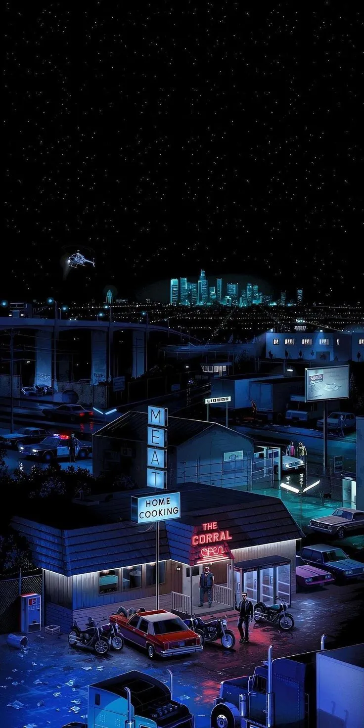 an aerial view of a city at night with cars parked in the lot and buildings lit up