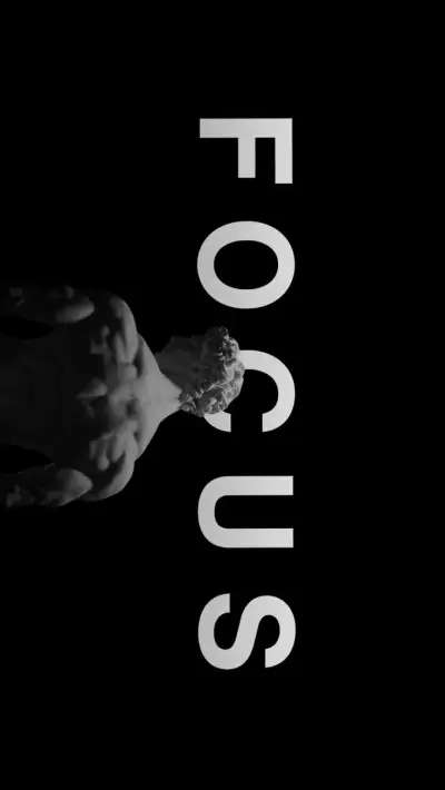 two hands holding something in front of the word focus on a black background with white letters