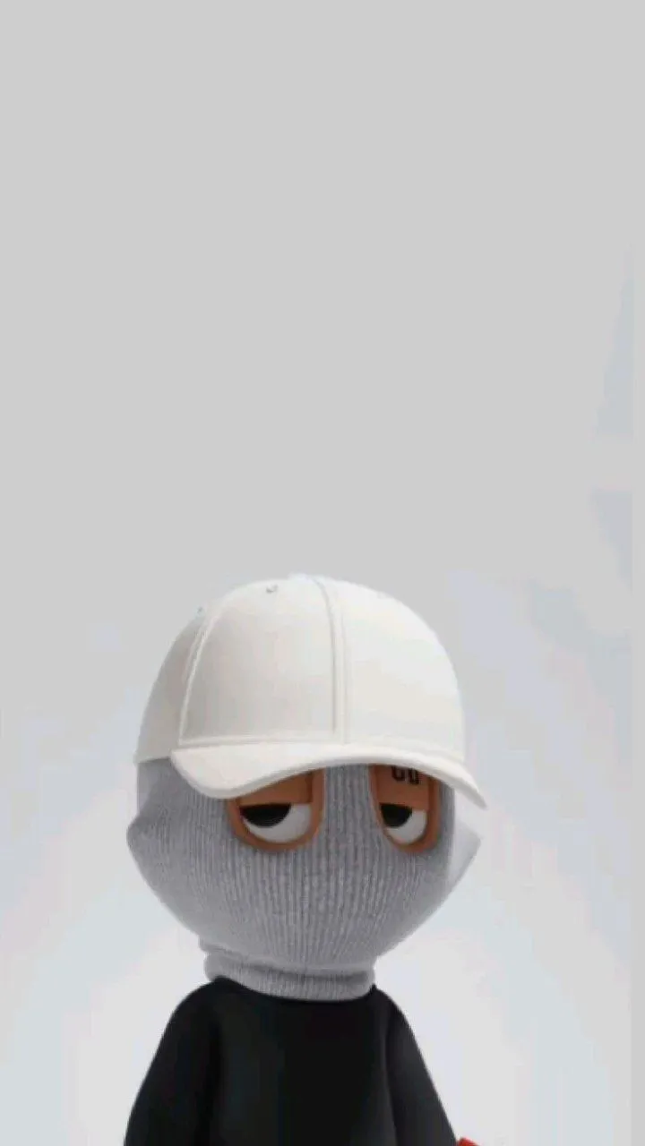 a person wearing a white hat and black shirt holding a red object in their hand