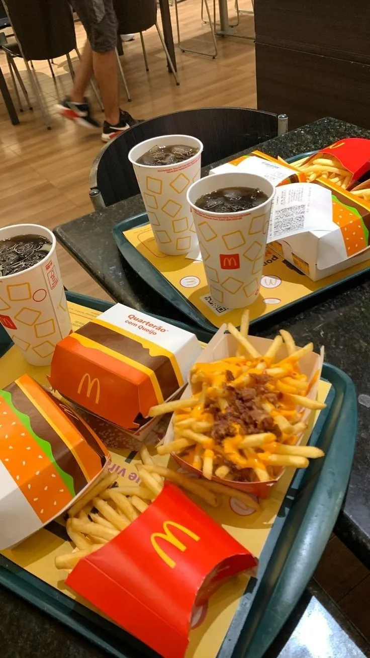 two trays filled with different types of food on top of a table next to each other